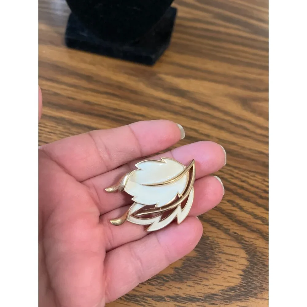 Crown Trifari gold tone and white enamel leaf design brooch